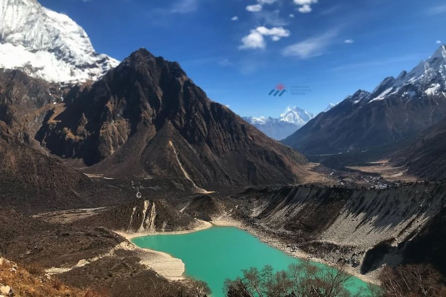 Turquoise glacial lake surrounded by snow-capped Himalayan peaks in the Manaslu region